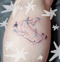 a man's leg with stars and a tattoo on it