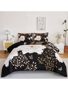 a black and white comforter with flowers on it