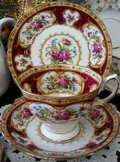 an antique tea cup and saucer with matching plates