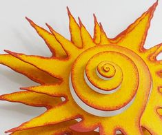 an orange and yellow sun with spirals on it