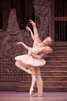 two ballerinas in white tutus and pink dresses