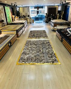 a store filled with lots of different types of rugs and floor coverings on display