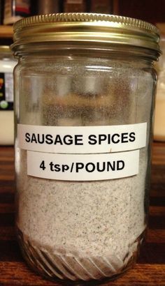 a jar filled with sand sitting on top of a wooden table