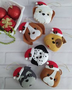 christmas ornaments are arranged on a white brick wall and include dogs, santa hats, and other holiday decorations