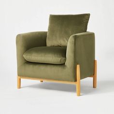 a green chair with a wooden frame and cushion