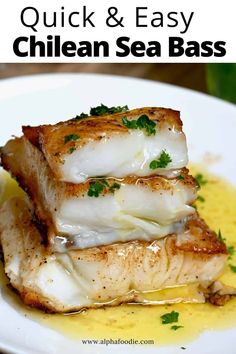 grilled sea bass on a white plate with lemon sauce and parsley garnish