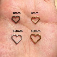 three small heart shaped charms are shown in different sizes and shapes, along with the measurements for each one