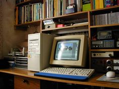 an old computer sitting on top of a wooden desk