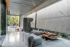 a living room with concrete walls and flooring