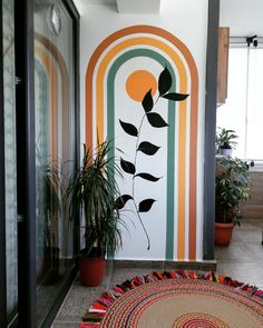 a room with a rug, potted plants and a painting on the wall