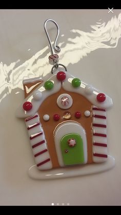 a christmas ornament with a gingerbread house on it