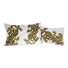 two pillows with yellow and black designs on them