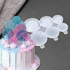 there is a cake that has been decorated with pink and blue icing on it