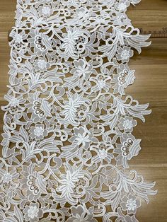 white lace with flowers on wooden floor