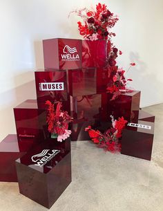 red vases with flowers are stacked on top of each other