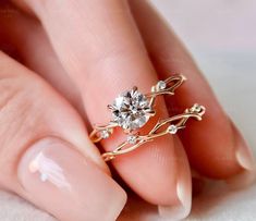 a close up of a person's hand with a ring on their finger and a diamond in the middle