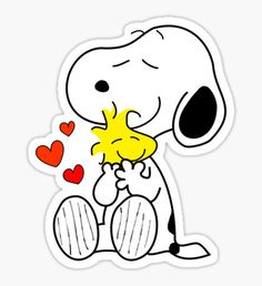 a cartoon snoopy dog holding a heart sticker