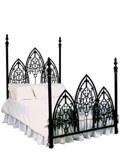 a black iron bed frame with white sheets and pillows on the bottom, in front of a white background