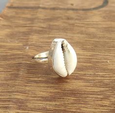 Cowrie Ring, Sterling Silver Shell Ring, Natural Shell Ring, Cowry Kauri Shell, best Ring, cowrie Silver Ring, Boho Yoga Ring, Gift for Her It brings good luck, wealth, prosperity, fame and the power of destiny. Cowry shells are used in some religious or auspicious ceremonies too, like in Laxmi puja cowrie shells are kept to please Goddess Laxmi and be blessed by Her and Lord Vishnu. Handmade White Shell Rings, White Shell-shaped Rings For Beach, White Shell Rings For The Beach, White Shell Rings For Beach, White Beach Ring Jewelry, Laxmi Puja, Shell Rings, Seashell Ring, Best Ring