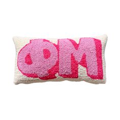 a pink and white pillow with the word omo on it's front side