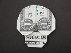 a dollar bill origami with the words happy halloween written on it and two smaller bills cut in half