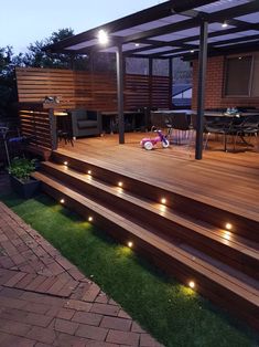 a deck with lights on it next to a patio