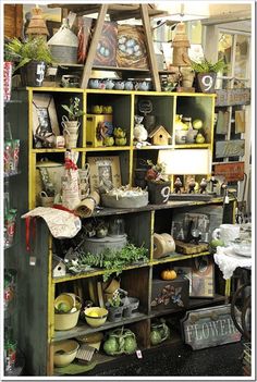 a room filled with lots of different types of furniture and decor on top of shelves