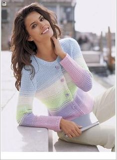 a beautiful woman sitting on top of a white bench