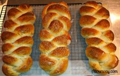 three different types of breads sitting on top of a cooling rack