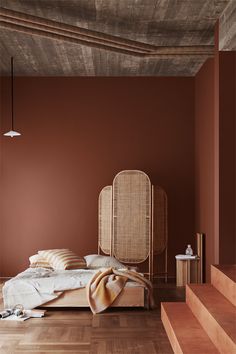 a bed sitting on top of a hard wood floor next to a wooden stair case