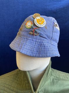 For Sale is a original 1970s Blue cotton bucket hat with a zip pocket side and original pin badges I love the 'character' on this - quite a few rust stains but it adds to the charm Tagged a size Medium, fits more like a modern unisex small.  Shipped safely and securely See my Positive feedback ! Vintage Cotton Hats For Outdoors, Vintage Cotton Hat For Outdoor, Retro Blue Bucket Hat With Curved Brim, Retro Blue Cap Hat, Retro Blue Bucket Hat, Vintage Denim Bucket Hat, Vintage Denim Blue Cap, England Shirt, Baby Sun Hat