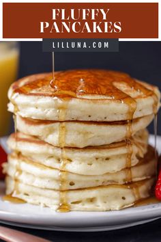 stack of fluffy pancakes with syrup drizzled on top