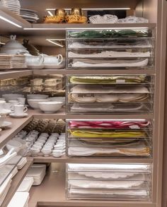 an open cabinet filled with lots of dishes