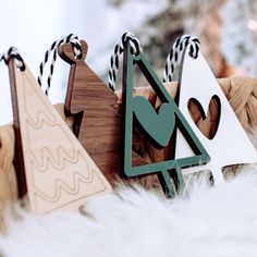 several wooden ornaments are on display in front of a christmas tree