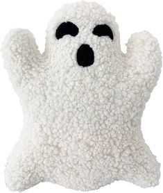 a white stuffed animal with black eyes and arms is in the shape of a ghost