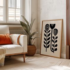 a living room with a couch, plant and window