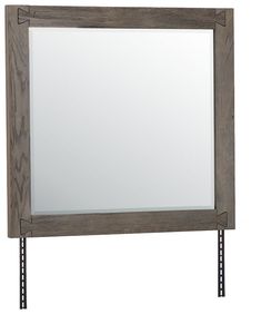 a wooden frame mirror hanging on a wall