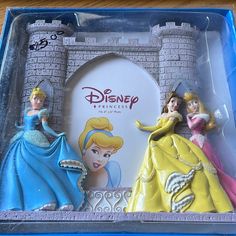 two disney princess figurines in a plastic box