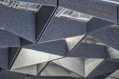 an abstractly designed building is shown from the ground down to the ceiling, and it appears to be made out of concrete