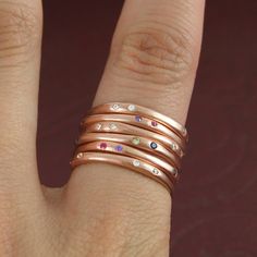 Detailed Description: Incredibly refined, these 18k rose gold plated stacking rings are dotted with tiny precious semi-precious gemstones - choose between sapphire and peridot, white topaz, or amethyst and ruby, creating a stellar effect.*PLEASE NOTE THE PRICE IS FOR A SINGLE STACKING RING ONLY* A modern designer masterpiece with added sparkle, this is the perfect gift for trendsetters and fashionistas! This bold and bright contemporary ring makes a great gift for birthdays, or super-cool fashionistas. Made from: Sterling Silver and a choice of Ruby/Amethyst, Sapphire/Peridot, and White Topaz.. Measurements: Diameter: approx. 2.0cm Rose Gold Eternity Ring, Ruby Band Ring, Gemstone Stacking Ring, Birthstone Stacking Rings, July Birthstone Ring, November Birthstone Ring, Topaz Birthstone, September Birthstone Rings, Eternity Ring Gold