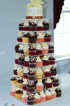 cupcakes are stacked on top of each other in the shape of a wedding cake