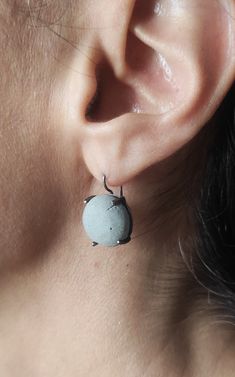 "These modern dangle  concrete  earrings are handmade from 925 silver  with oxidized finish.Τhe shape of the concrete is an round cabochon and its color is grey.Add a touch of modernity to your outfit with these round cabochon concrete earrings. In contact with skin, moisture and air, concrete becomes darker. Αs each piece is individually handmade, slight variations in texture are possible. DESCRIPTIONS and MEASUREMENTS: Materials:Oxidized silver. Surface: Concrete. Diameter:1,5 (cm) 0,59 (in)\". Total length: 2,3 (cm) 0,90 (in)\".                                            SEE MORE CONCRETE JEWELRY HERE: www.etsy.com/shop/ArtisJewels?ref=seller-platform-mcnav§ion_id=36353295 Visit my Etsy shop, ArtisJewels, to see more earrings and jewelry and other unique handmade pieces. www.etsy.com/sh Gray Drop Earrings For Pierced Ears, Gray Jewelry For Pierced Ears As A Gift, Minimalist Oxidized Dangle Earrings, Gray Ear Wire Earrings For Gift, Gray Sterling Silver Dangle Earrings, Gray Drop Earrings For Gift, Gray Drop Earrings, Minimalist Gray Sterling Silver Jewelry, Minimalist Gray Jewelry For Everyday