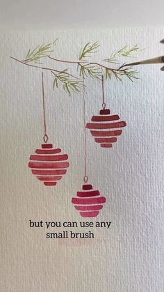 two ornaments hanging from a branch with the words, but you can use any small brush