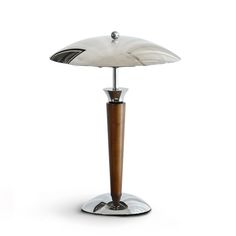 a lamp that is on top of a metal stand with a wooden base and glass shade