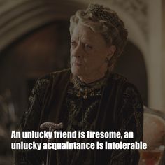 an older woman sitting in front of a fire place with the caption, an unlucky friend is awesome, an utterly