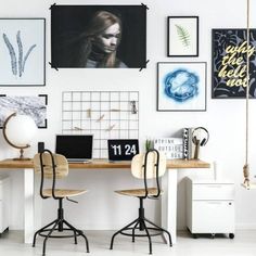 an office with white walls and lots of pictures on the wall, including two desks