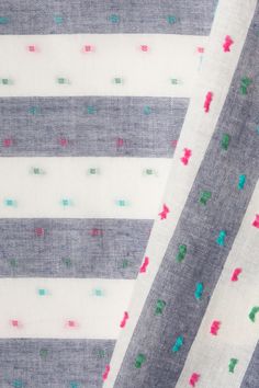 two pieces of fabric with different colored dots on the top and bottom of each piece