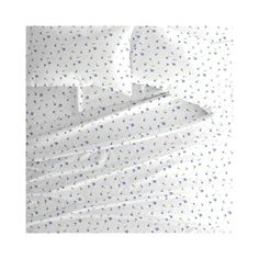 an unmade bed with white sheets and blue polka dots