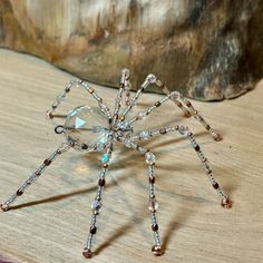 a crystal spider sitting on top of a wooden table