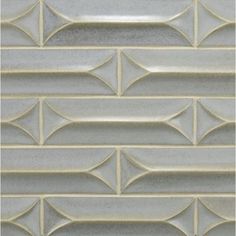 a close up view of a white tile wall with wavy lines on the bottom and sides